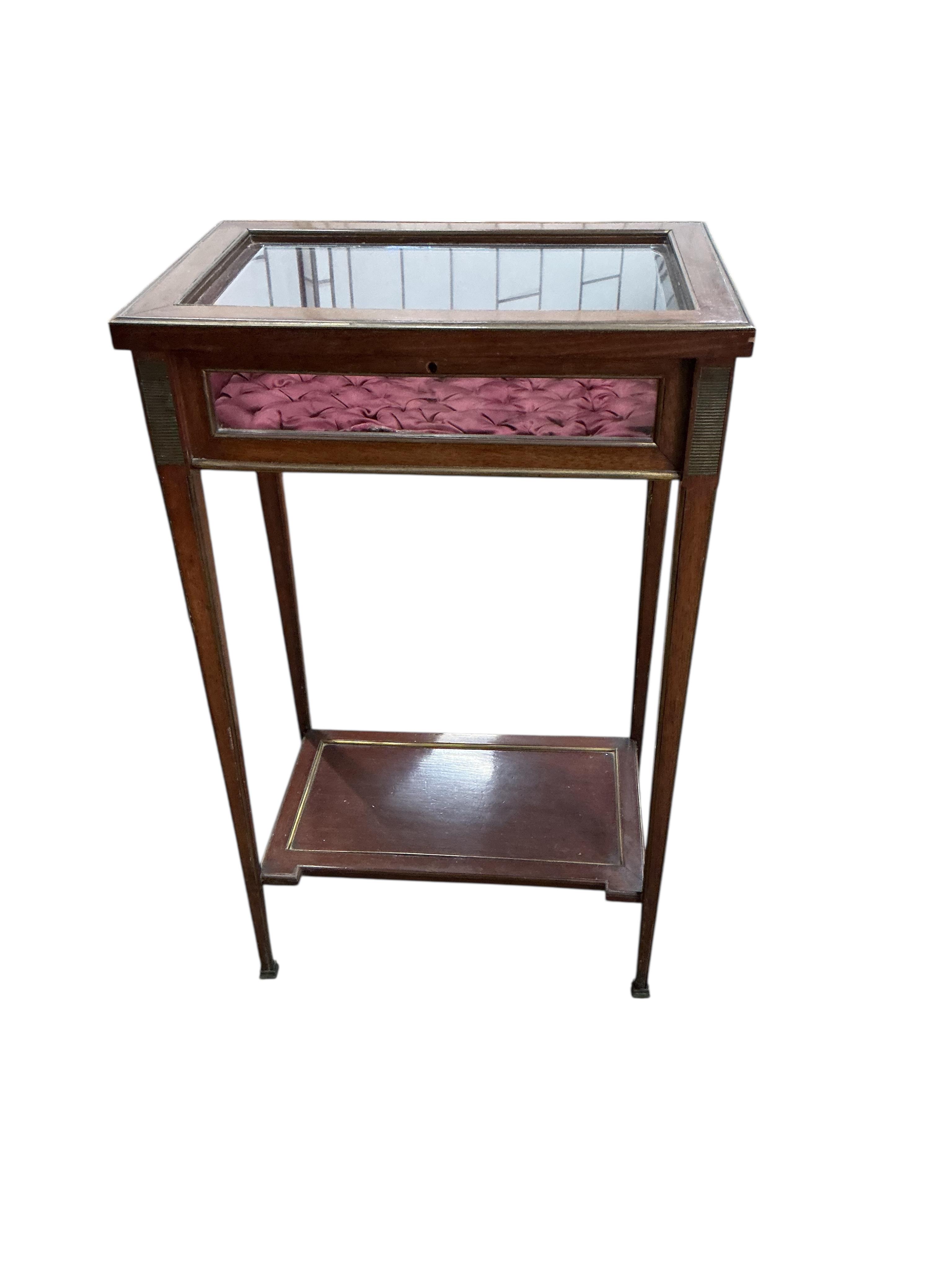 An early 20th century French brass mounted mahogany bijouterie table, label affixed inside reading: 26 Rue de Charonne, Passage de L'Homme. E. Mougin, width 43cm, depth 28cm, height 70cm